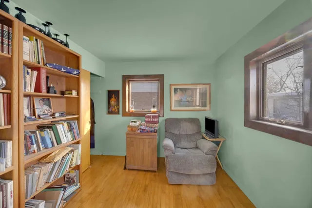 a living room with furniture and a book shelf