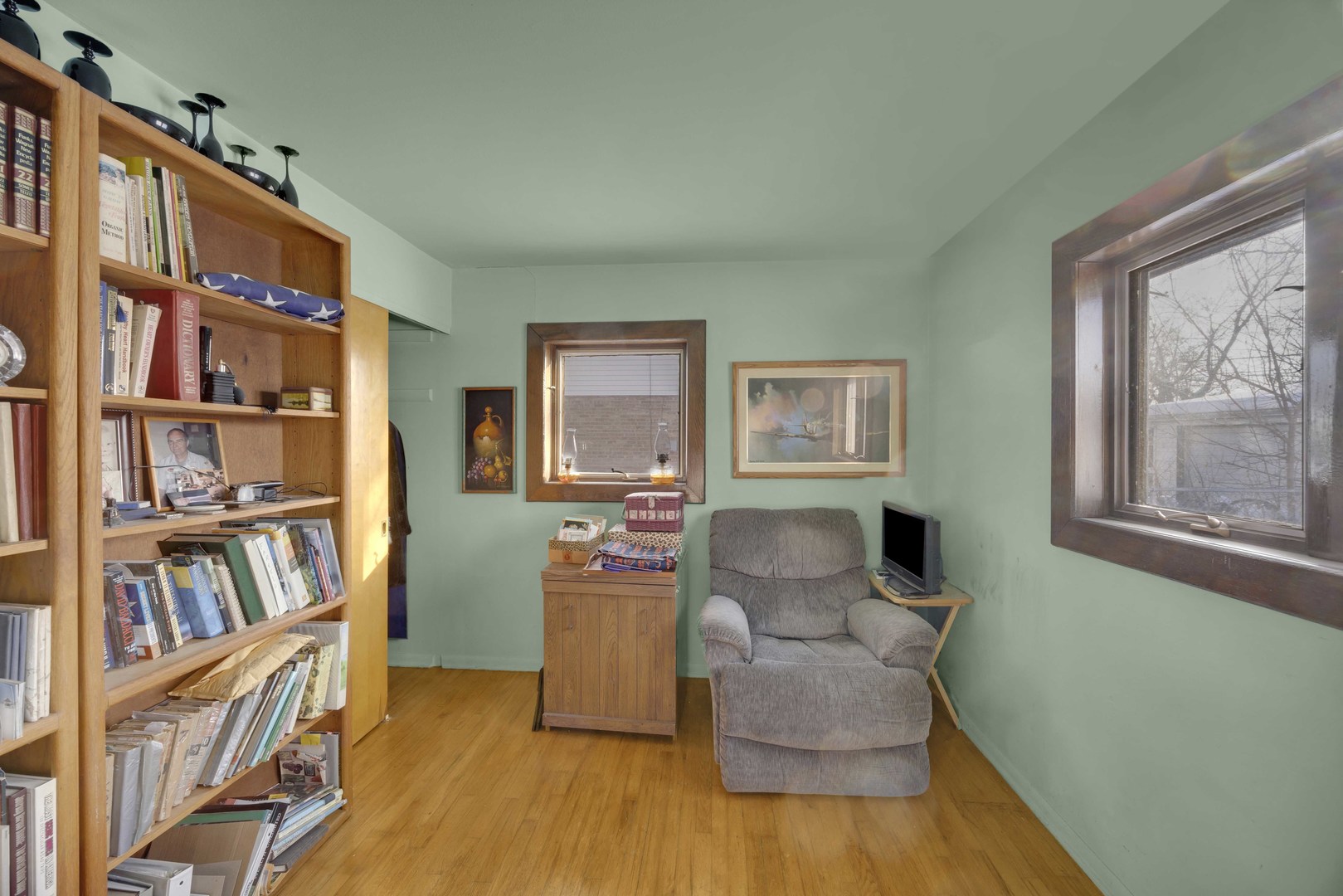 7101 Birch Street Bridgeview, IL 60455 - Photo 3 of 18 a living room with furniture and a book shelf