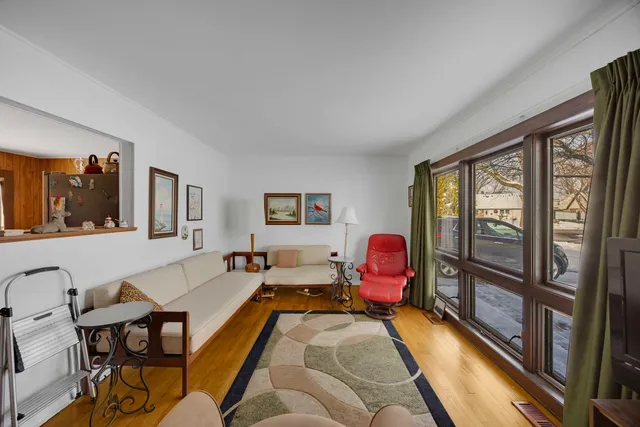 a living room with furniture a flat screen tv and a window