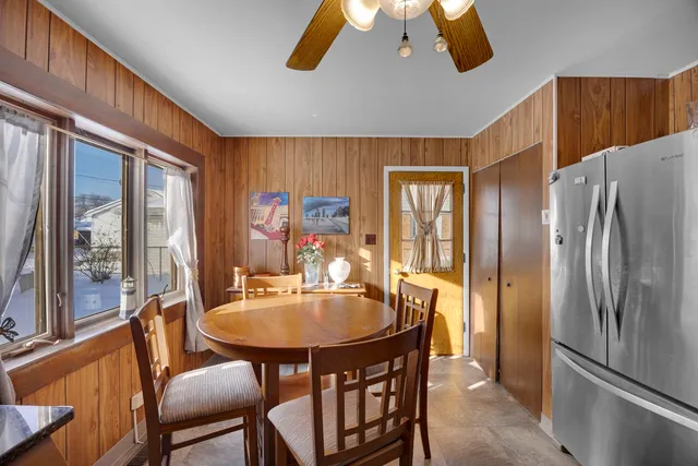 a dining room with furniture a chandelier and window