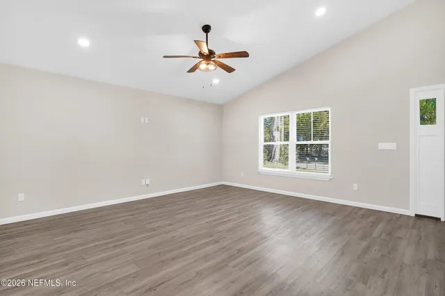 wooden floor in an empty room with a window