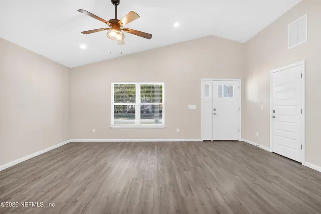 wooden floor in an empty room with a window