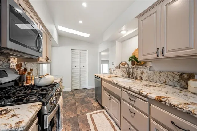 a kitchen with a sink stove and refrigerator