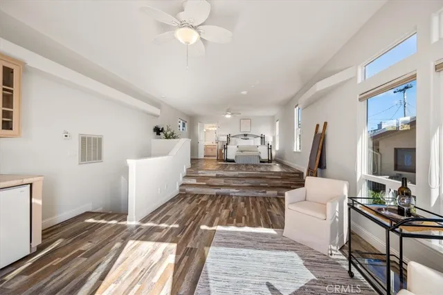 a balcony of a house with wooden floor and outdoor seating