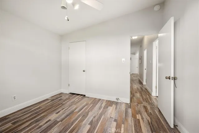a view of a house with brick walls and a yard with plants