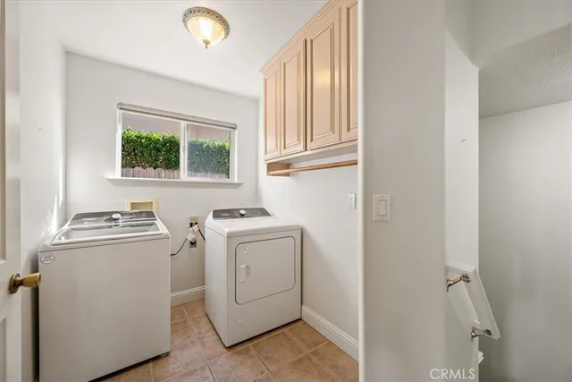 a view of a backyard with plants and wooden fence