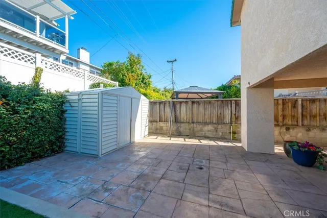 a view of a house with a yard and potted plants