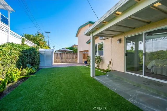 a front view of a house with a garden and plants