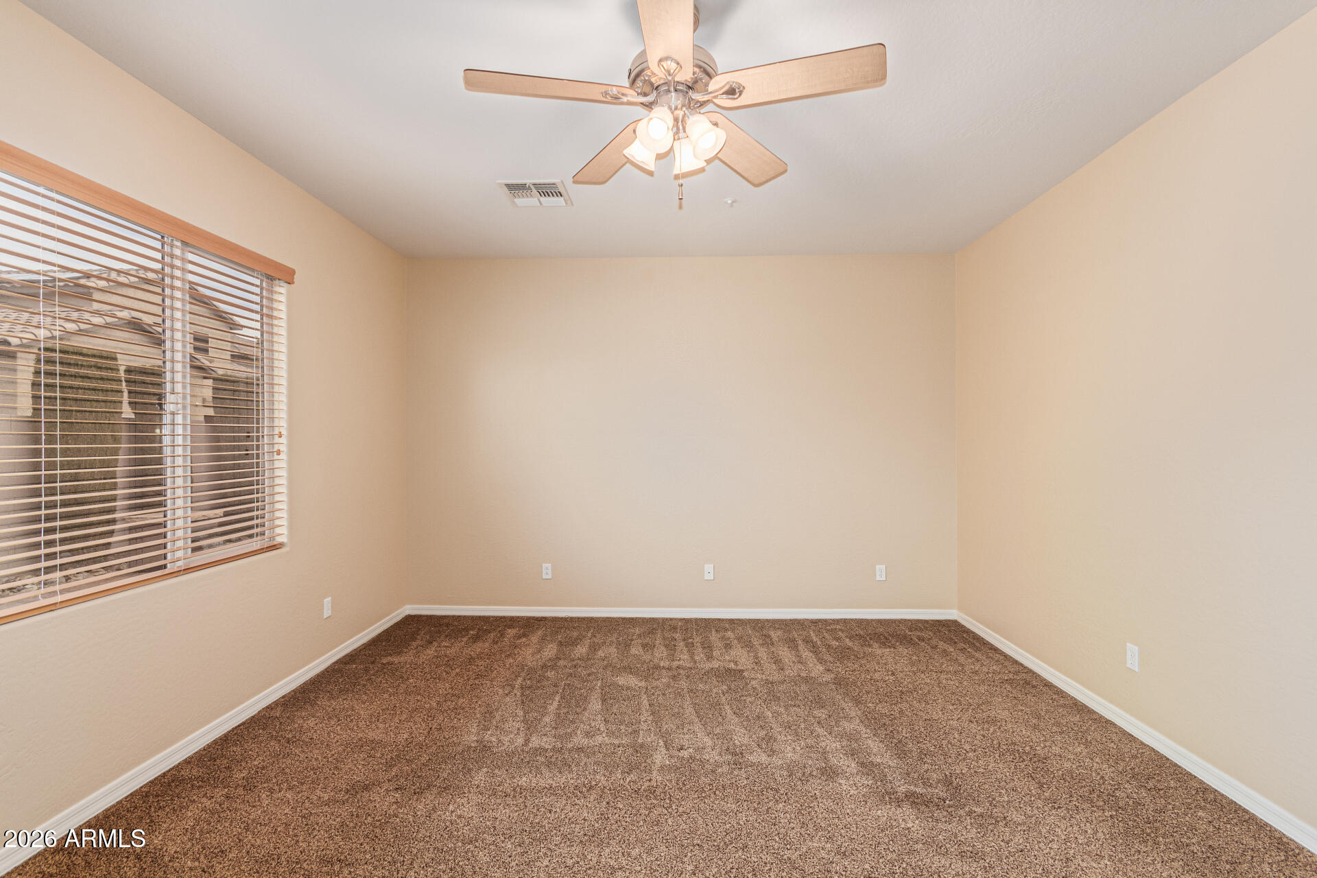 9058 West Redbird Road Peoria, AZ 85383 - Photo 14 of 39 an empty room with a window and a fan