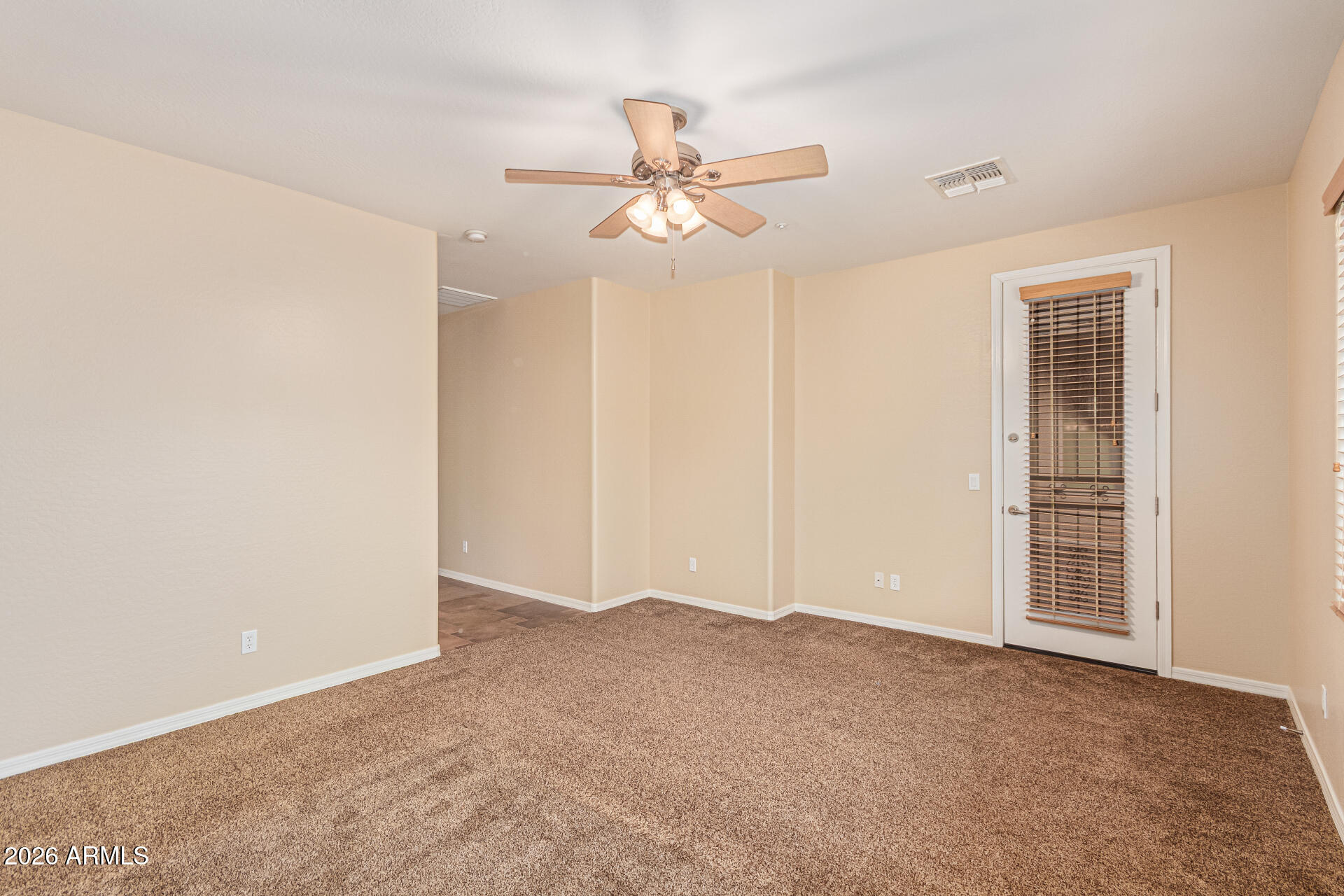9058 West Redbird Road Peoria, AZ 85383 - Photo 15 of 39 a view of an empty room with a ceiling fan