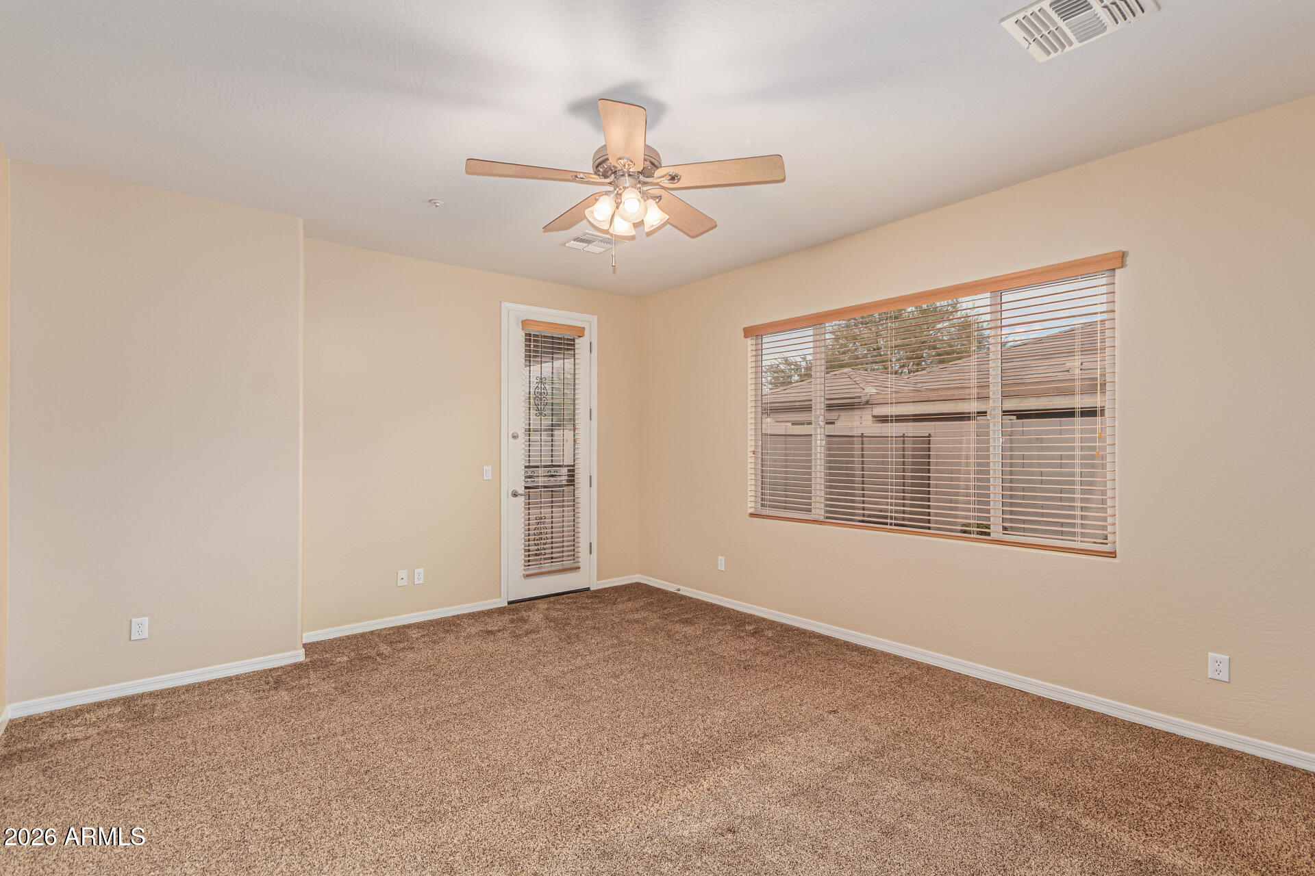 9058 West Redbird Road Peoria, AZ 85383 - Photo 16 of 39 an empty room with windows and fan