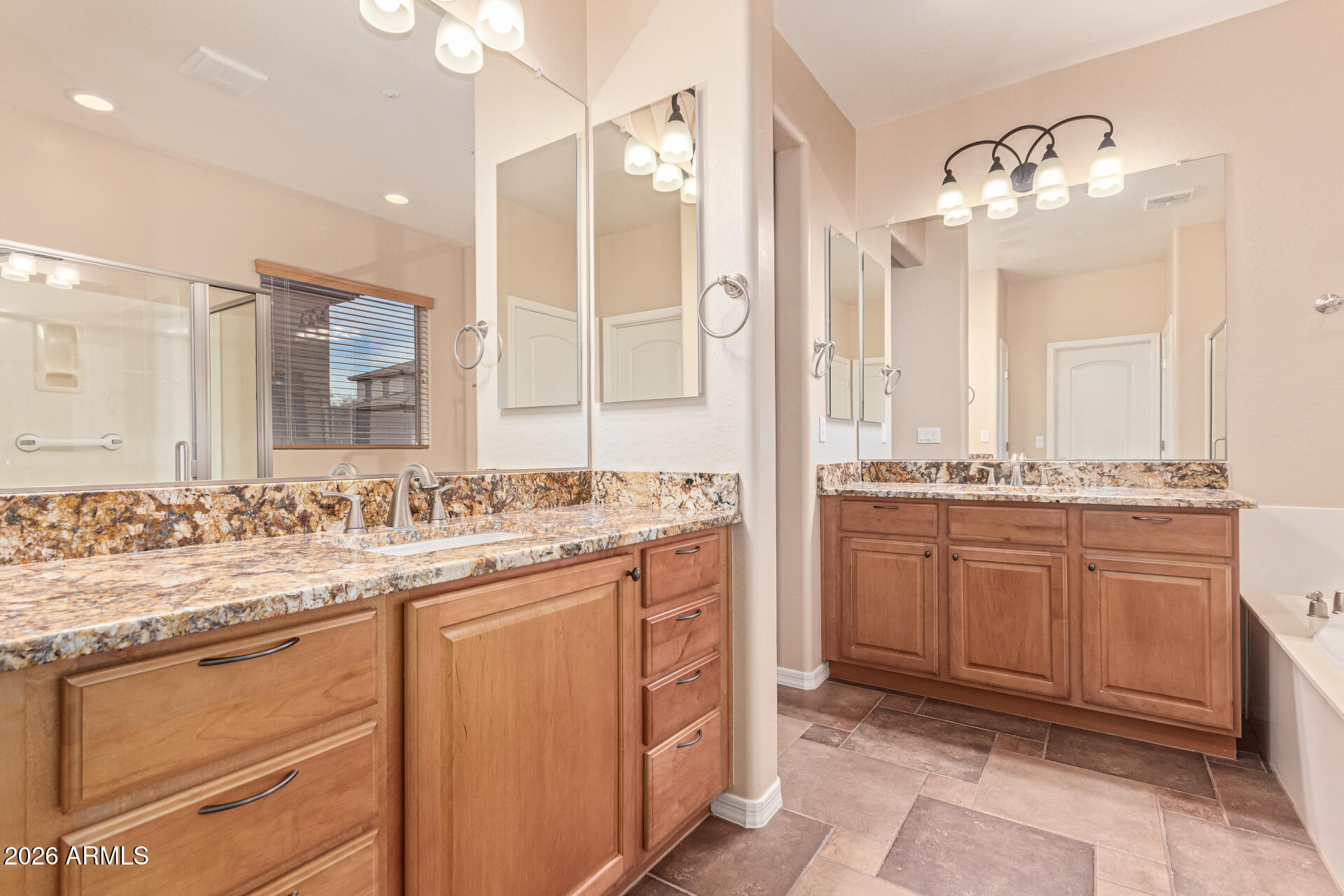 9058 West Redbird Road Peoria, AZ 85383 - Photo 17 of 39 a bathroom with a granite countertop sink a mirror and a shower