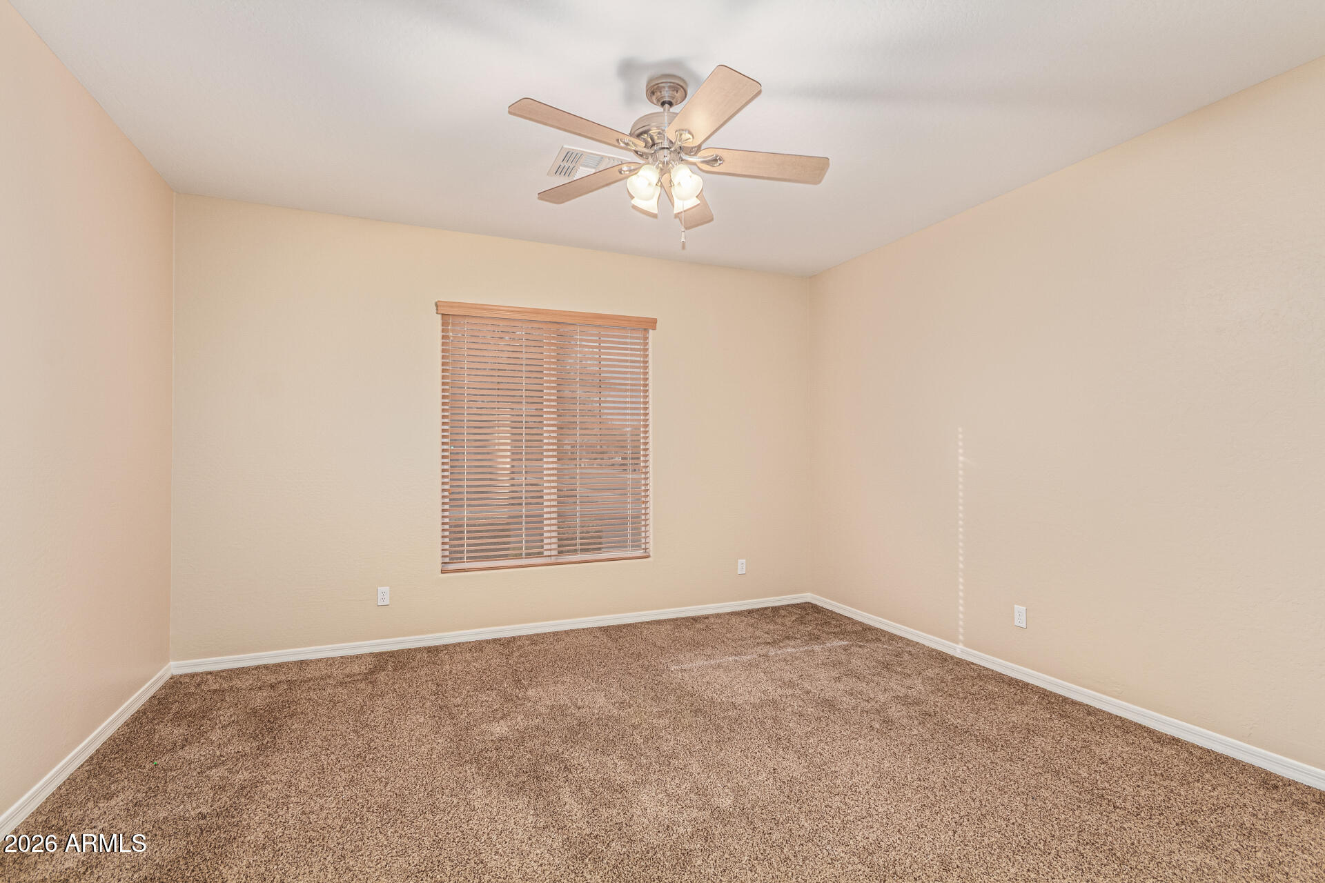 9058 West Redbird Road Peoria, AZ 85383 - Photo 20 of 39 an empty room with a window and a ceiling fan