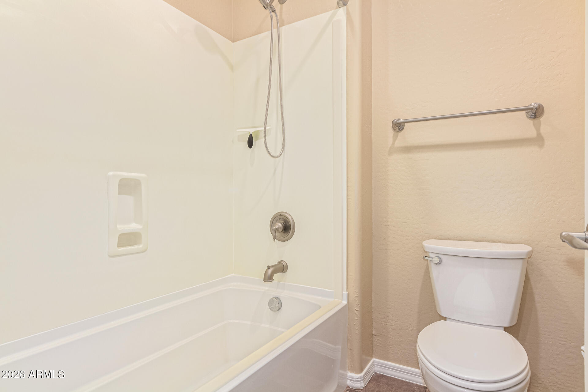 9058 West Redbird Road Peoria, AZ 85383 - Photo 24 of 39 a bathroom with a toilet and a bathtub