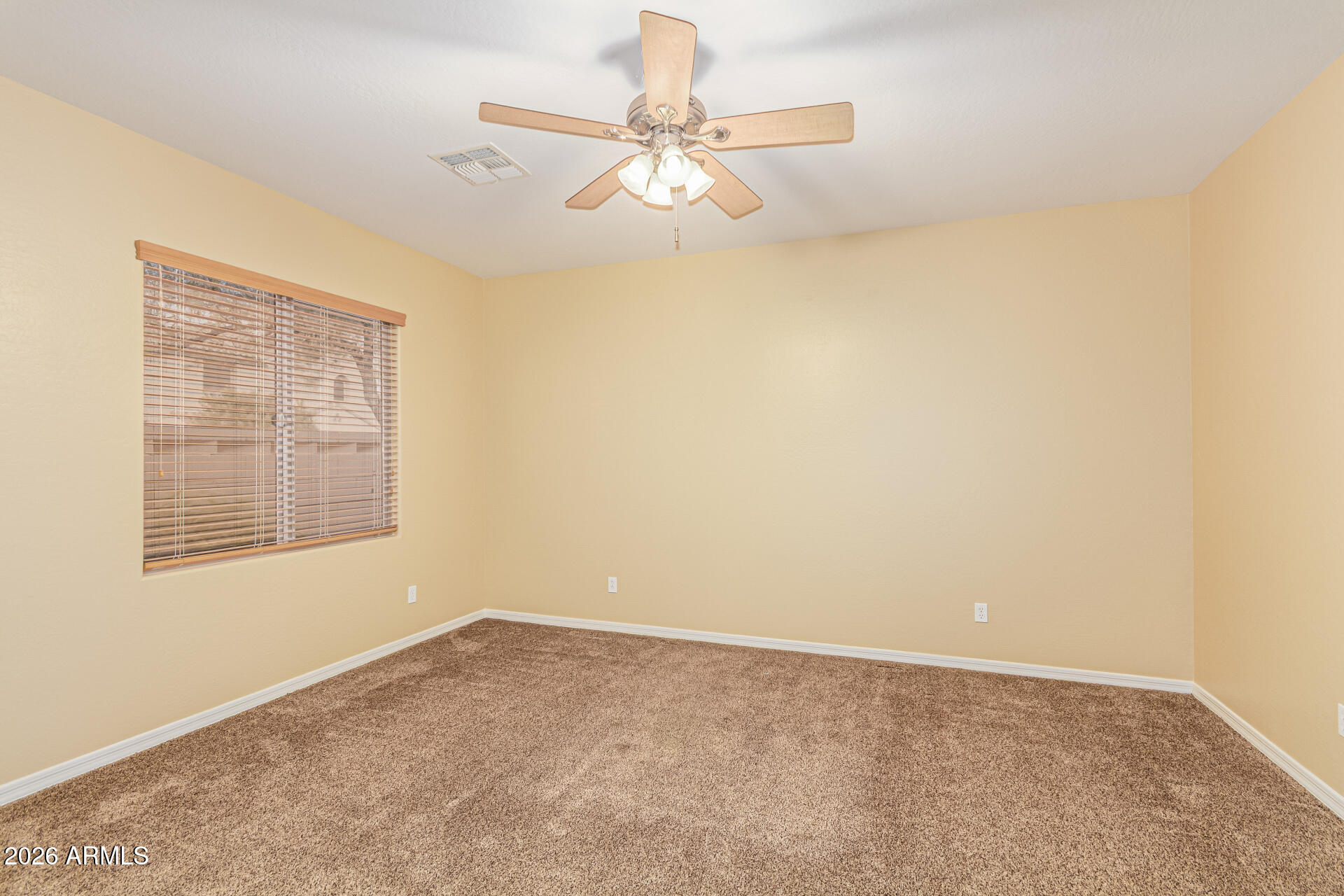 9058 West Redbird Road Peoria, AZ 85383 - Photo 25 of 39 an empty room with a window and a fan