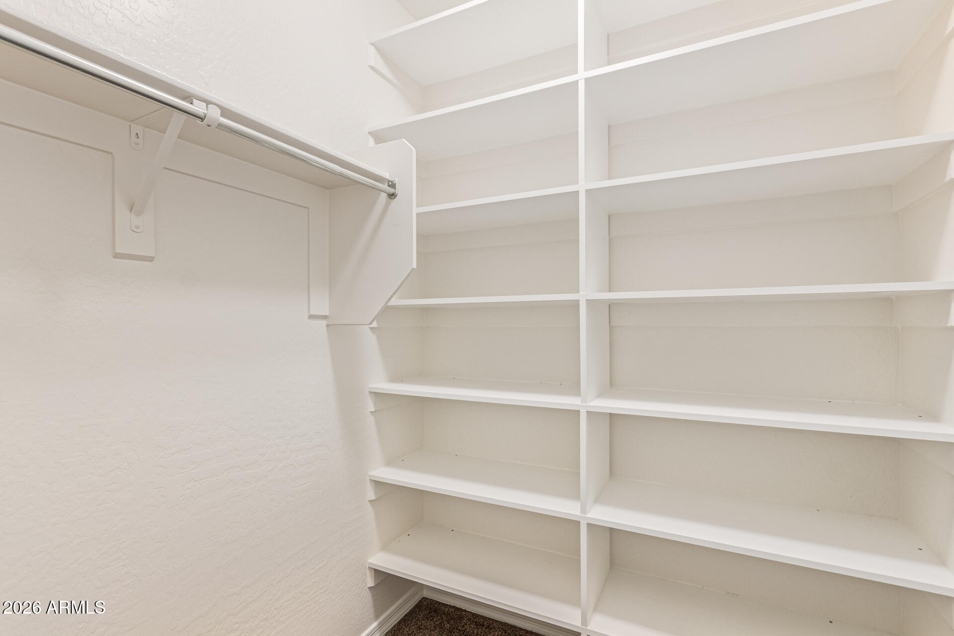 9058 West Redbird Road Peoria, AZ 85383 - Photo 27 of 39 a view of walk in closet with empty racks