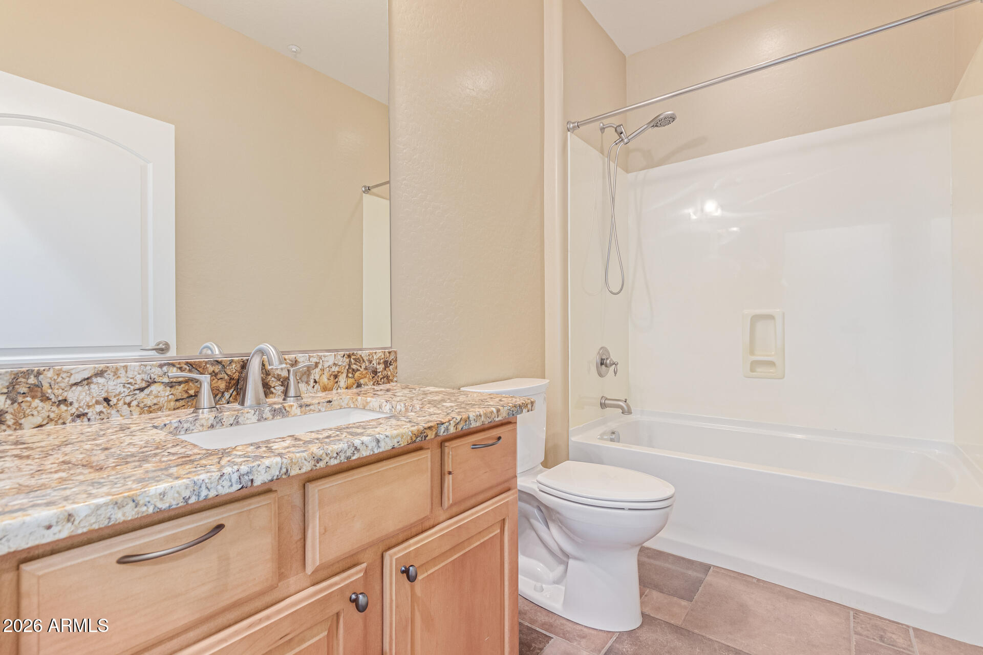 9058 West Redbird Road Peoria, AZ 85383 - Photo 28 of 39 a bathroom with a granite countertop sink a toilet and a large mirror