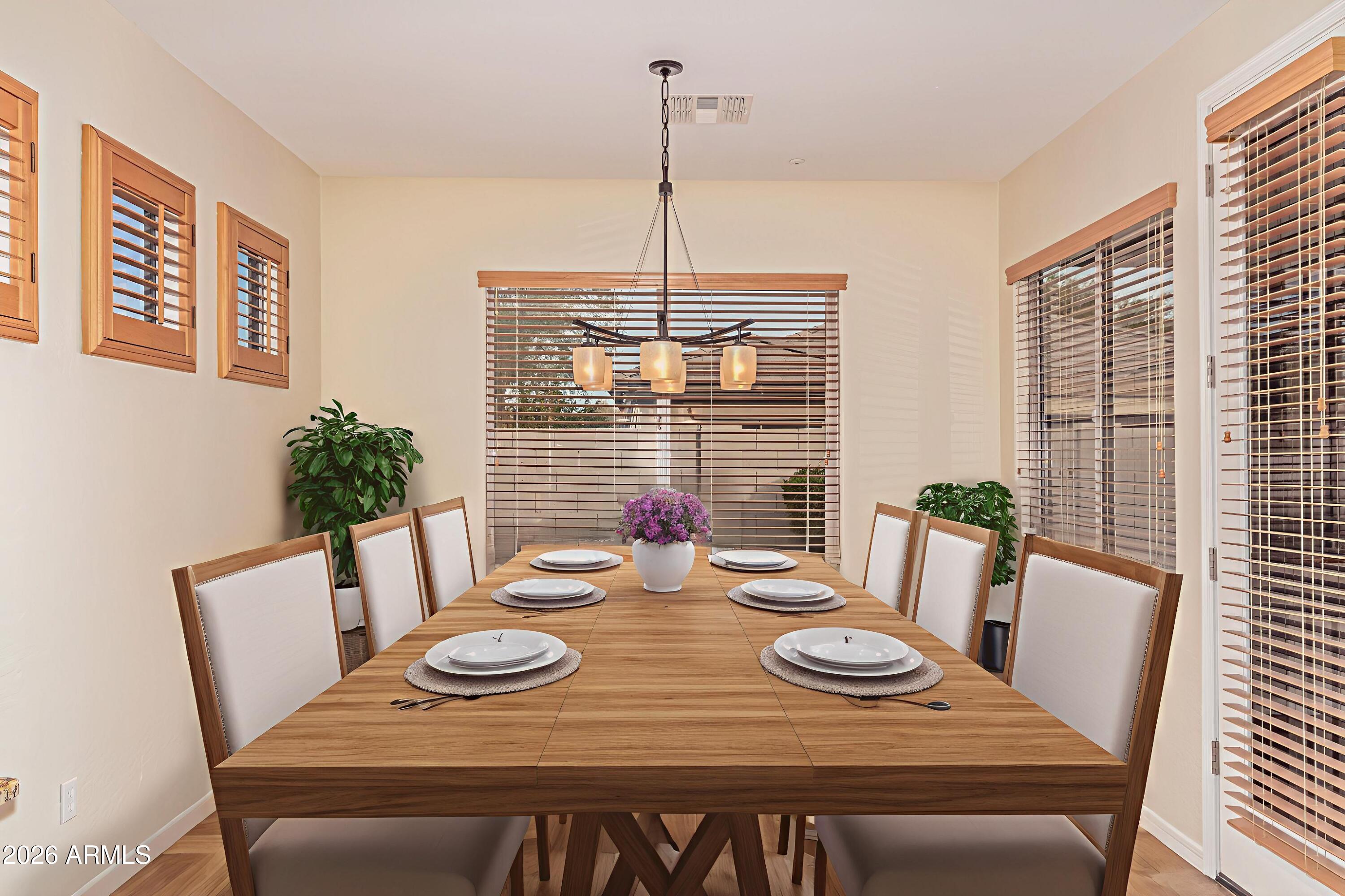 9058 West Redbird Road Peoria, AZ 85383 - Photo 3 of 39 a view of a dining room with furniture window and wooden floor