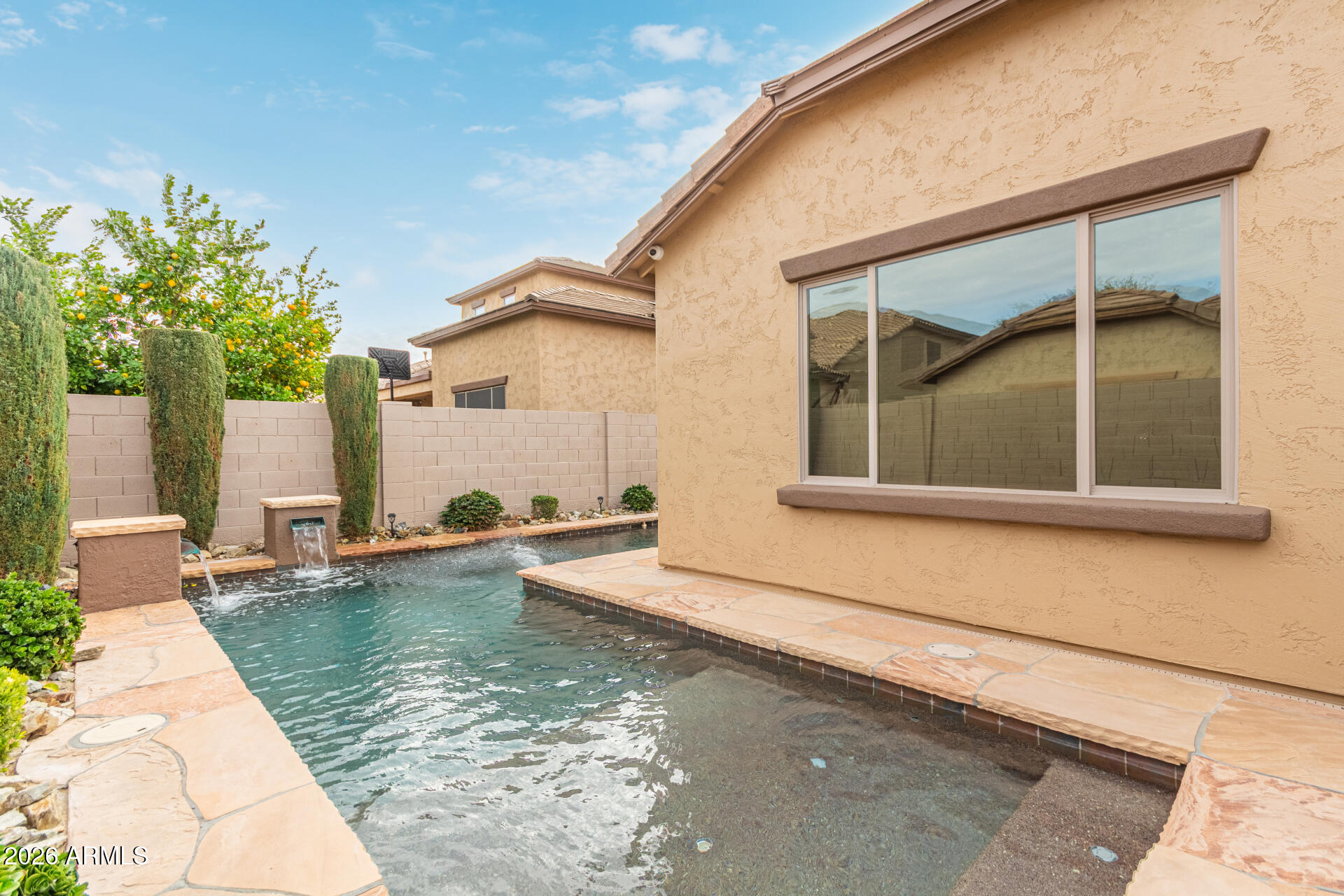 9058 West Redbird Road Peoria, AZ 85383 - Photo 37 of 39 a view of a house with a swimming pool