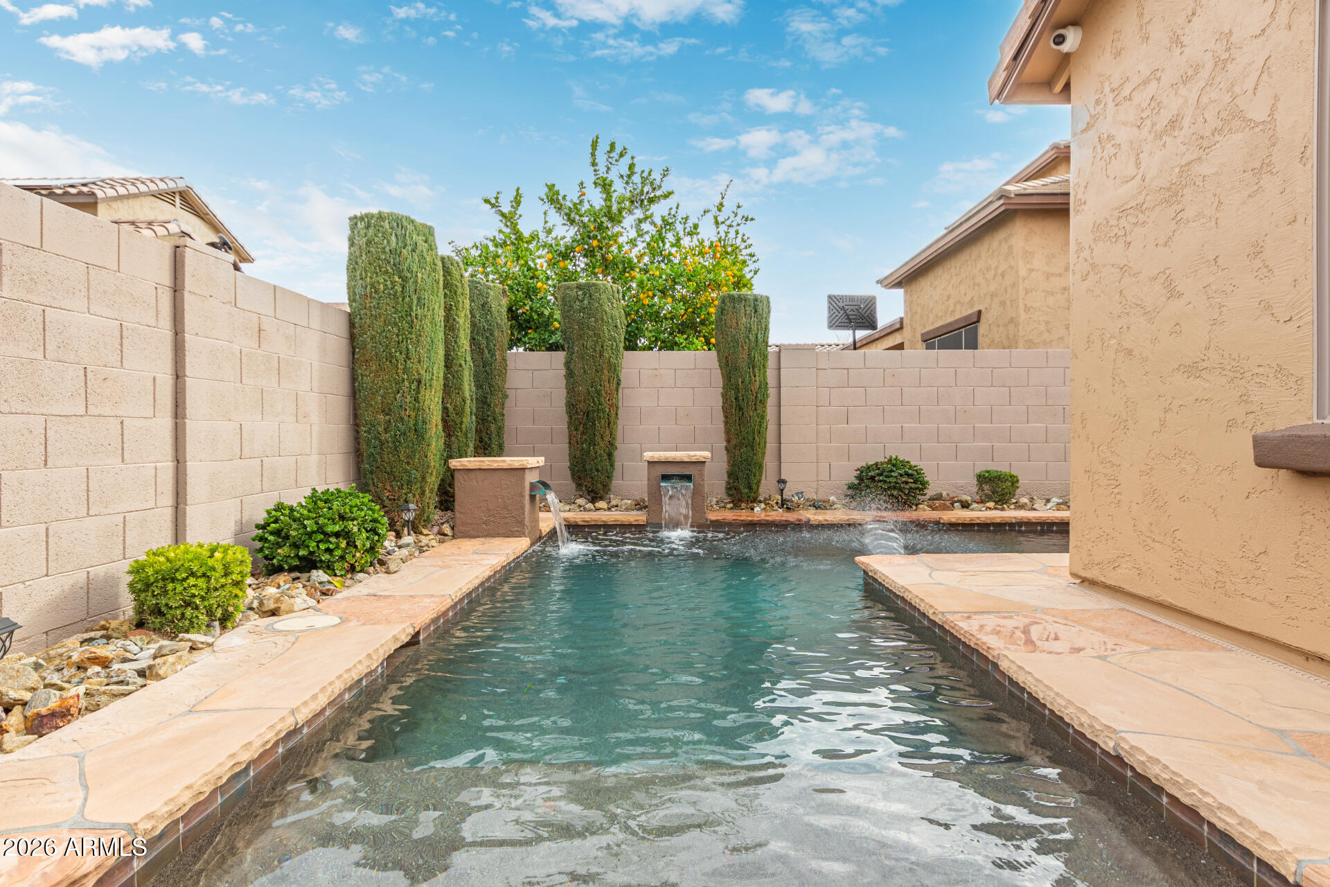 9058 West Redbird Road Peoria, AZ 85383 - Photo 39 of 39 a view of a swimming pool with a lounge chair