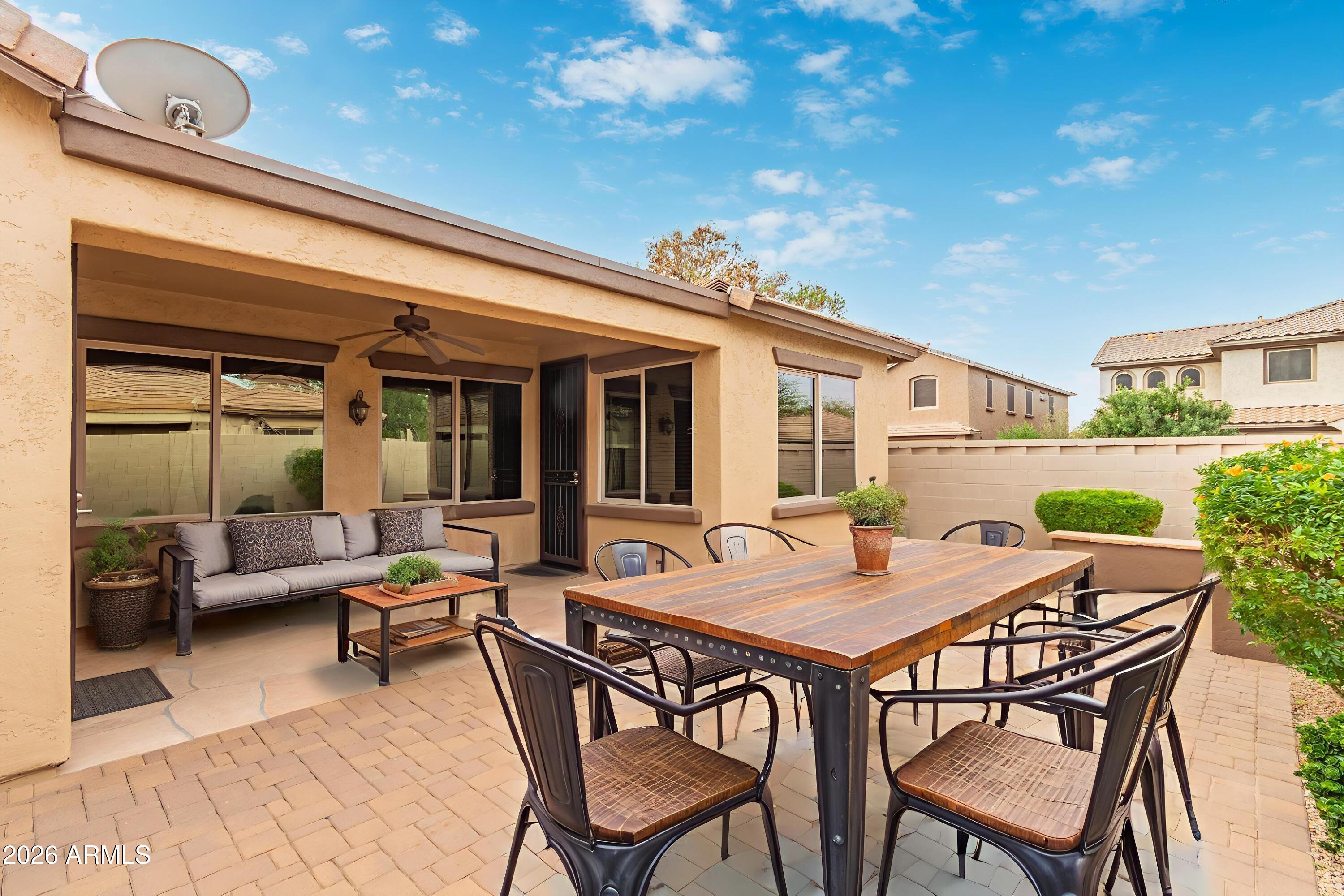 9058 West Redbird Road Peoria, AZ 85383 - Photo 5 of 39 a view of a dinning table and chairs in patio of the house