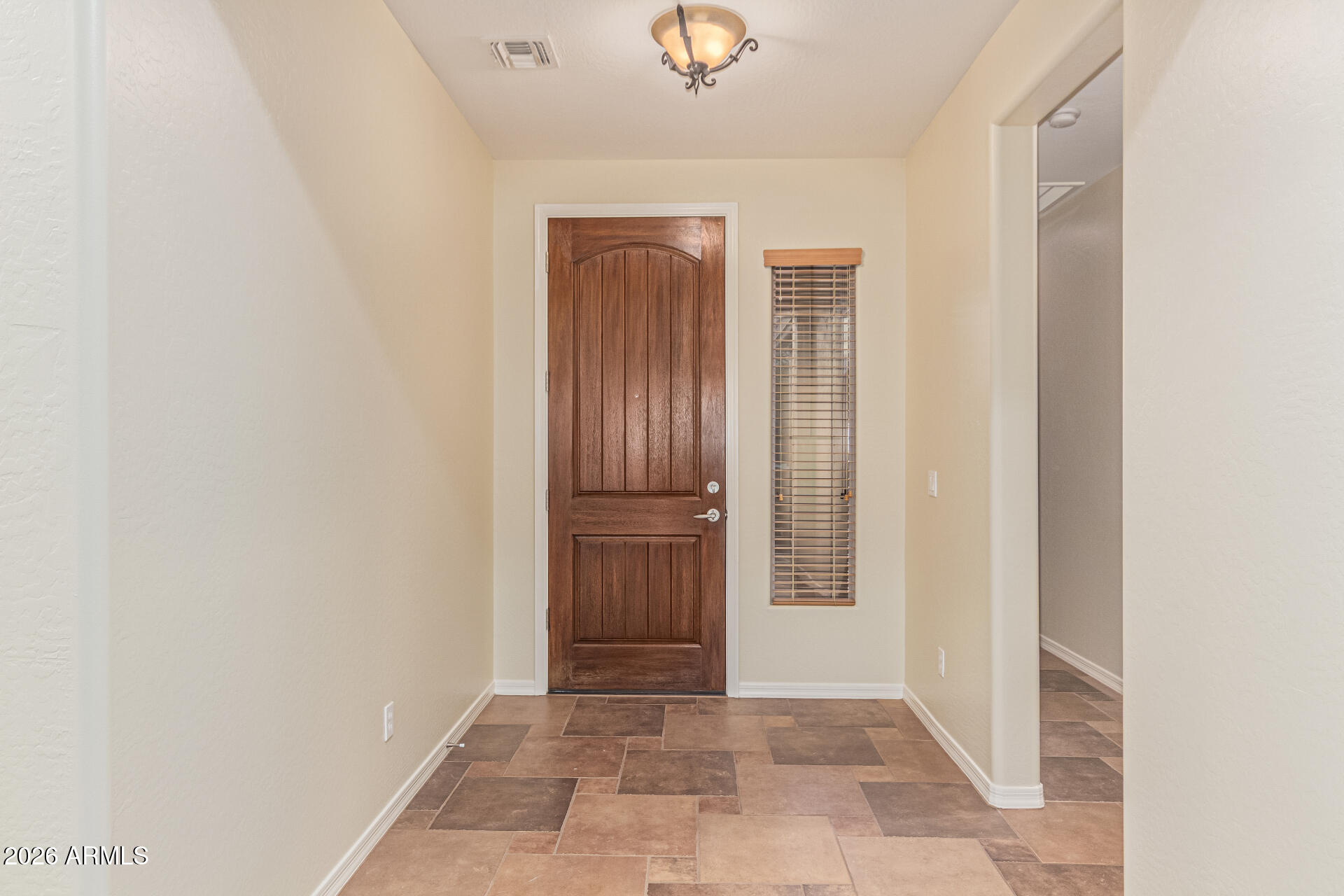 9058 West Redbird Road Peoria, AZ 85383 - Photo 6 of 39 a view of an entryway with wooden floor