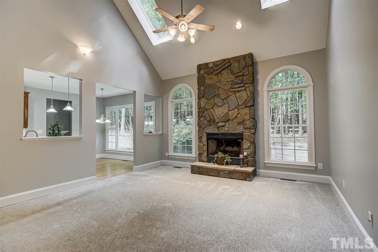 10424 Roadstead Way West Raleigh, NC 27613 - Photo 11 of 29 a view of a livingroom with a fireplace a ceiling fan and window