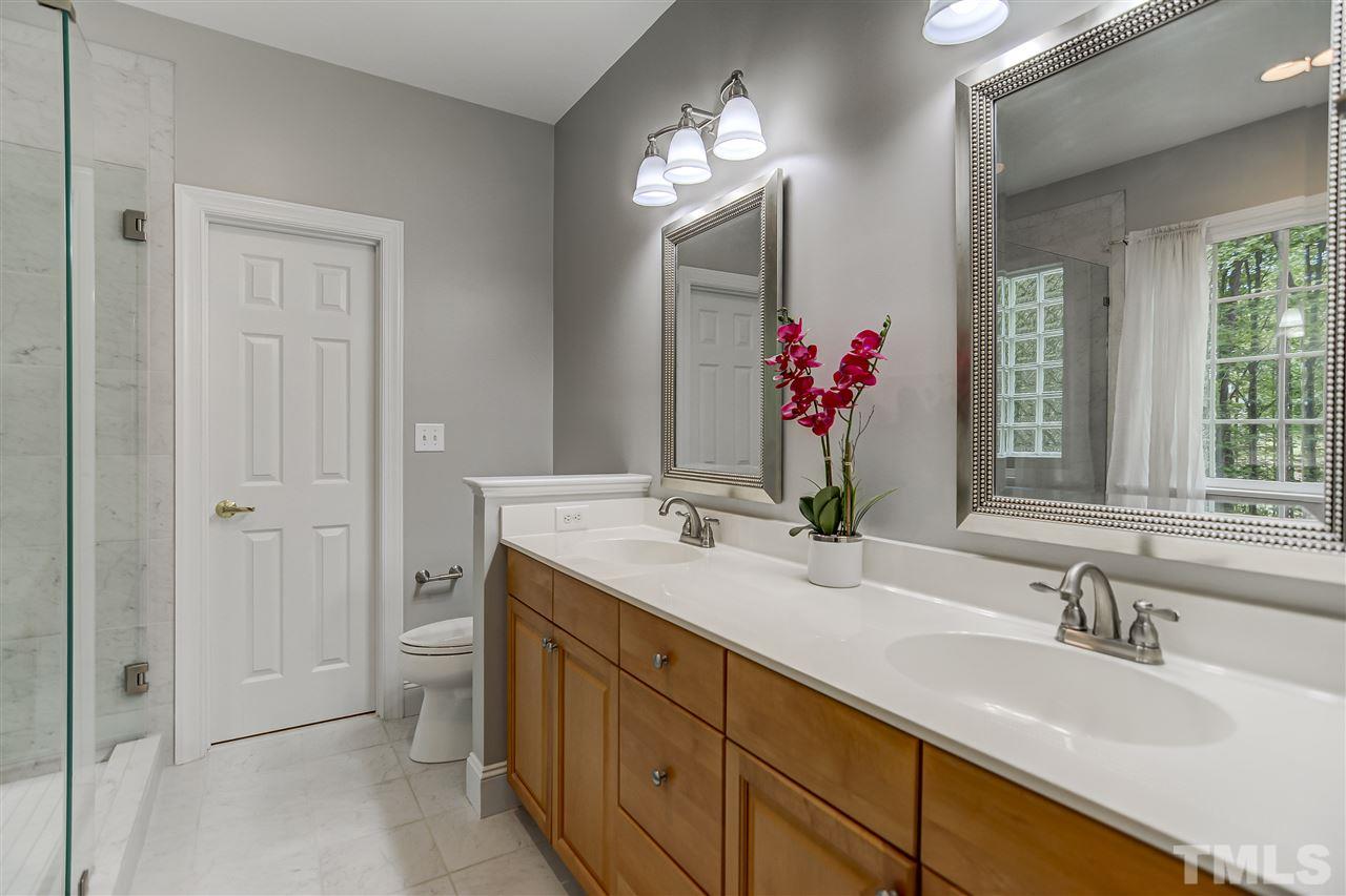 10424 Roadstead Way West Raleigh, NC 27613 - Photo 17 of 29 a bathroom with a double vanity sink mirror and next to a window
