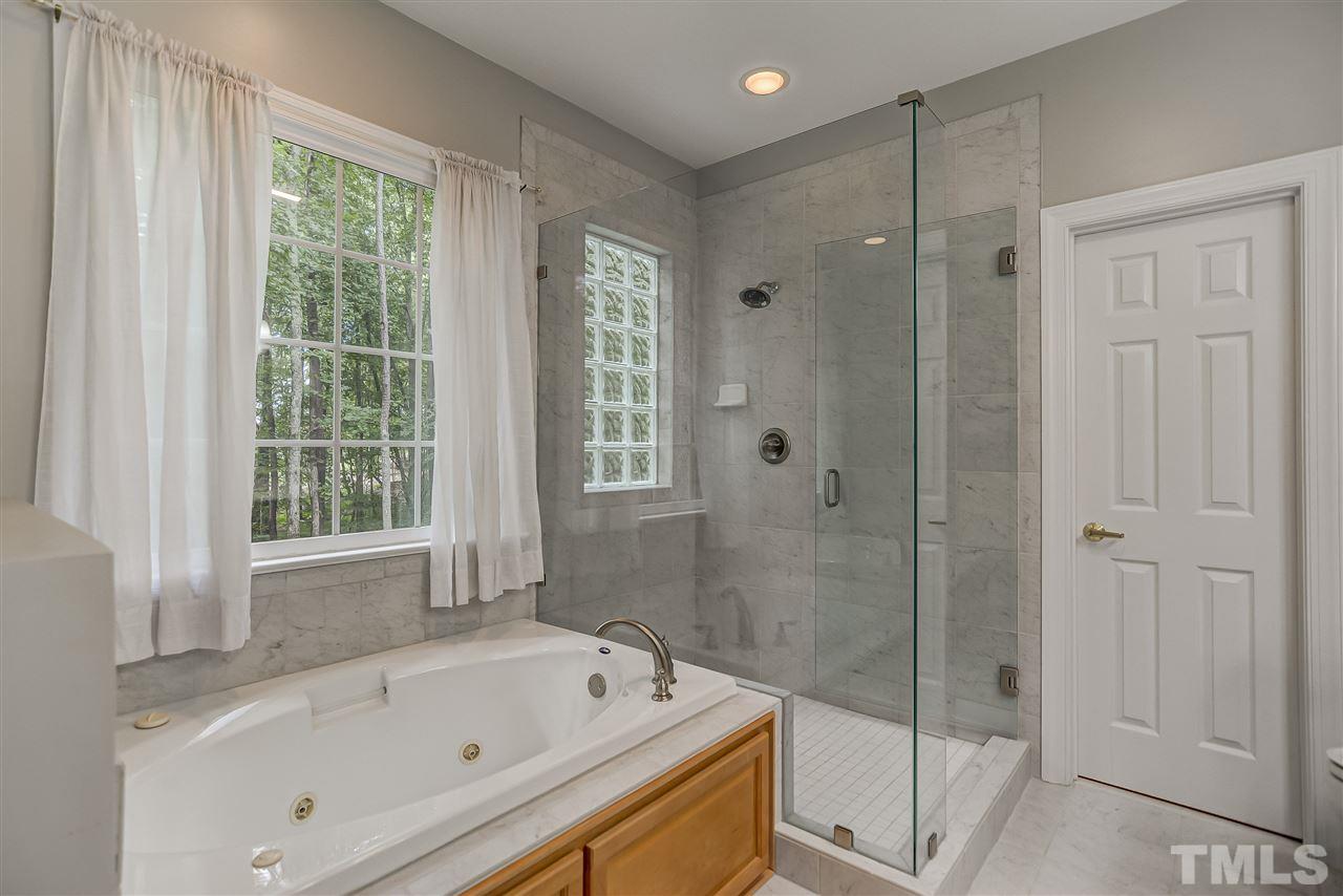 10424 Roadstead Way West Raleigh, NC 27613 - Photo 18 of 29 a bathroom with a bathtub and a shower