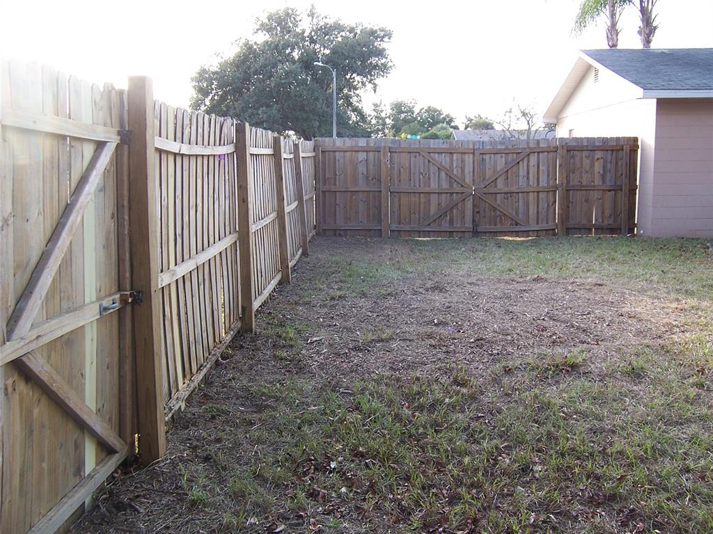 2703 Middle Street Orlando, FL 32807 - Photo 13 of 18 a view of a backyard with wooden fence