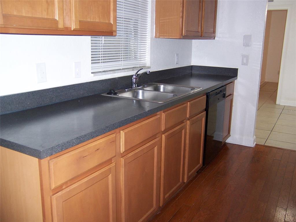 2703 Middle Street Orlando, FL 32807 - Photo 8 of 18 a kitchen with granite countertop sink and cabinets