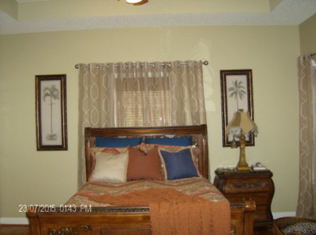 130 Riverbend Road Jackson, GA 30233 - Photo 12 of 29 a bed sitting in a bedroom next to a window