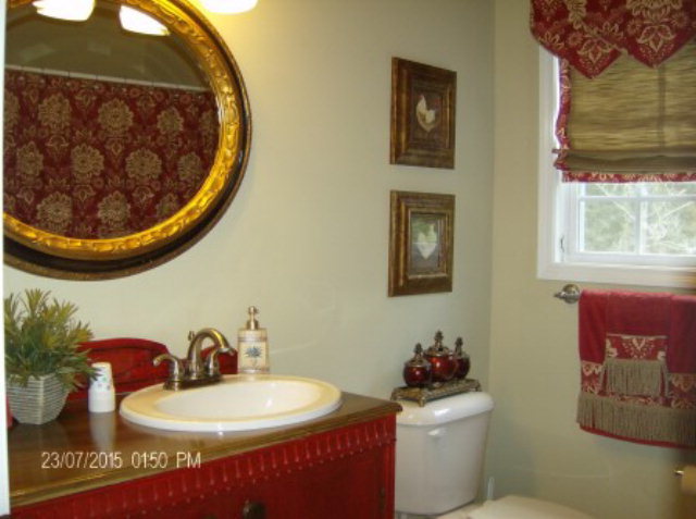 130 Riverbend Road Jackson, GA 30233 - Photo 17 of 29 a bathroom with a toilet a sink and a mirror