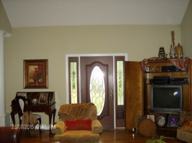 130 Riverbend Road Jackson, GA 30233 - Photo 5 of 29 a living room with furniture a fireplace and a flat screen tv