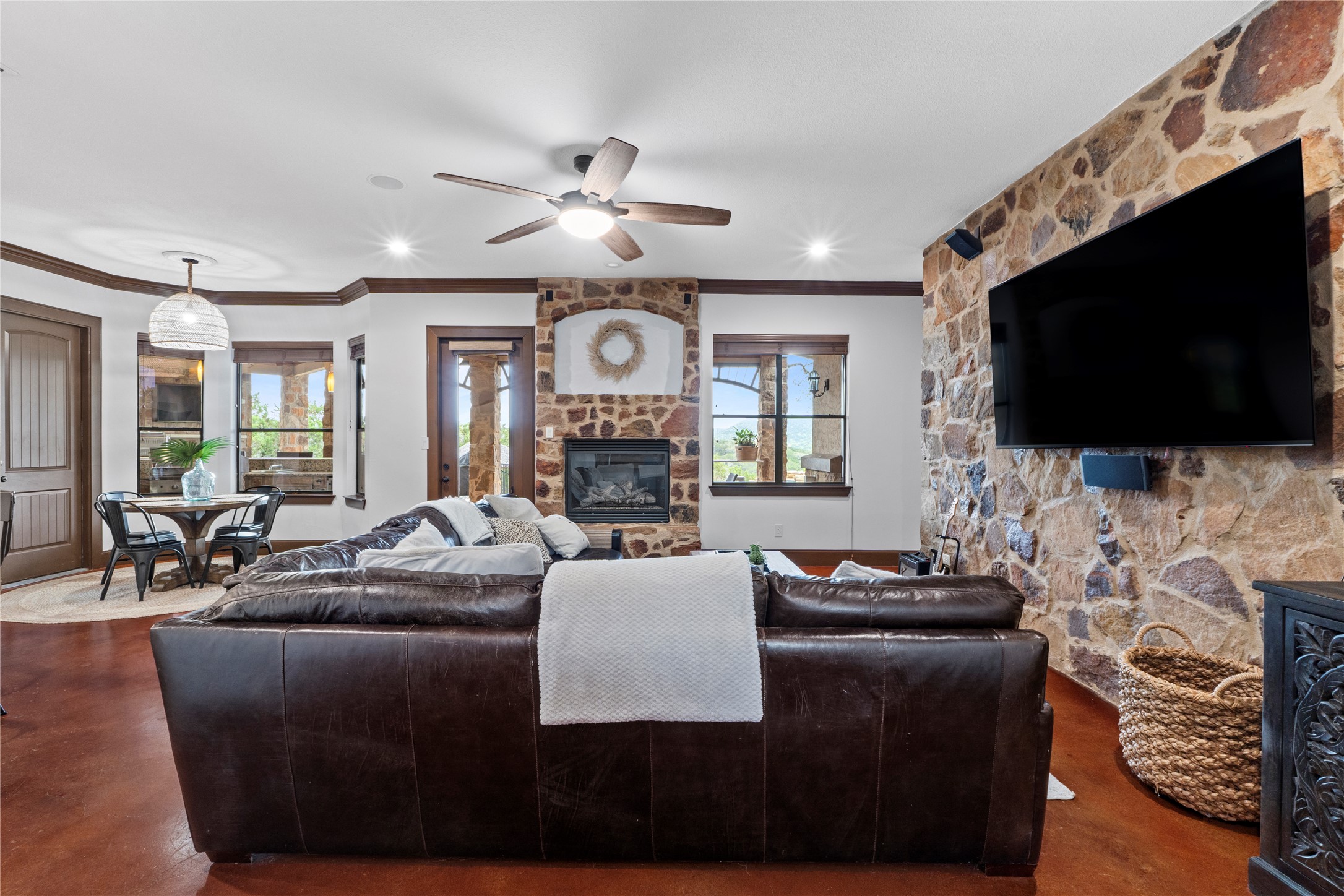 8211 Moon Rise Trail Jonestown, TX 78645 - Photo 13 of 34 Family room with fireplace and stone accent wall, opens onto the beautiful lower patio.