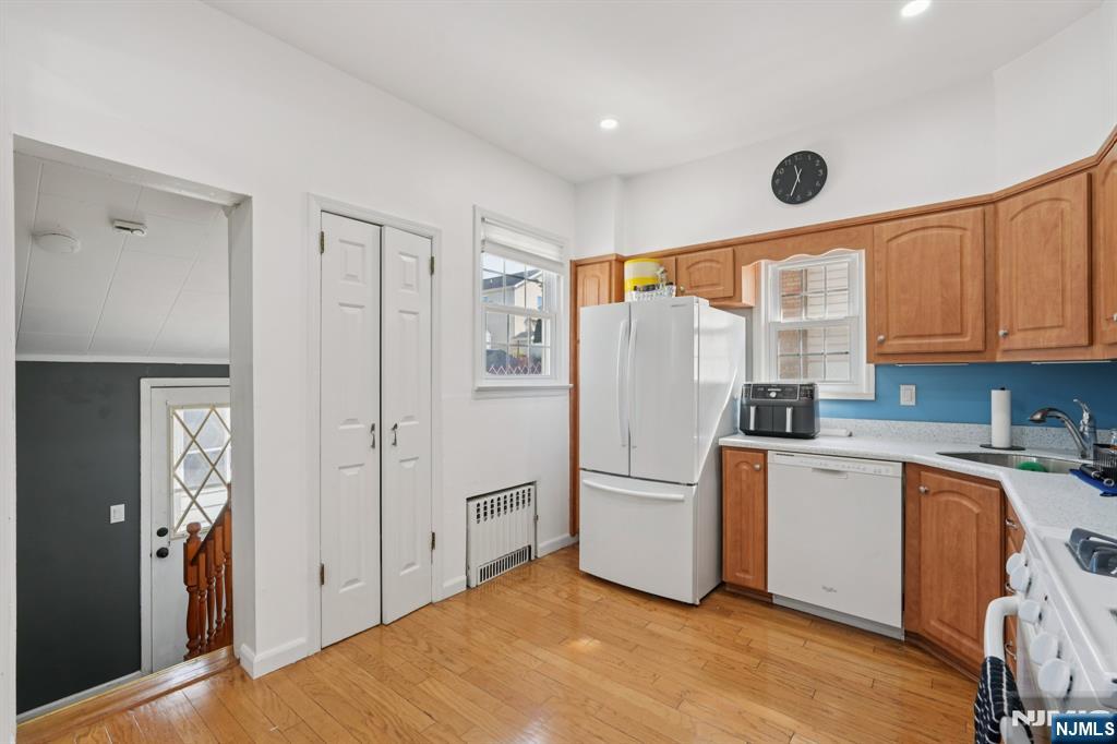 471 Harding Avenue Lyndhurst, NJ 07071 - Photo 19 of 50 a kitchen with a refrigerator a stove top oven a sink and dishwasher with wooden floor