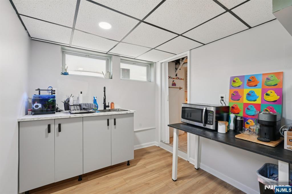 471 Harding Avenue Lyndhurst, NJ 07071 - Photo 26 of 50 a kitchen with stainless steel appliances granite countertop a sink dishwasher and cabinets with wooden floor