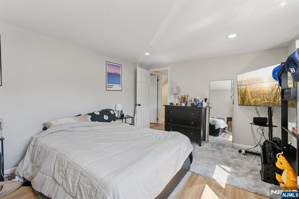 471 Harding Avenue Lyndhurst, NJ 07071 - Photo 38 of 50 a bedroom with a bed and a flat tv screen on dresser