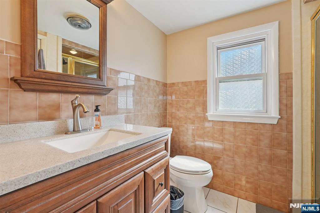 471 Harding Avenue Lyndhurst, NJ 07071 - Photo 45 of 50 a bathroom with a sink a toilet and a mirror