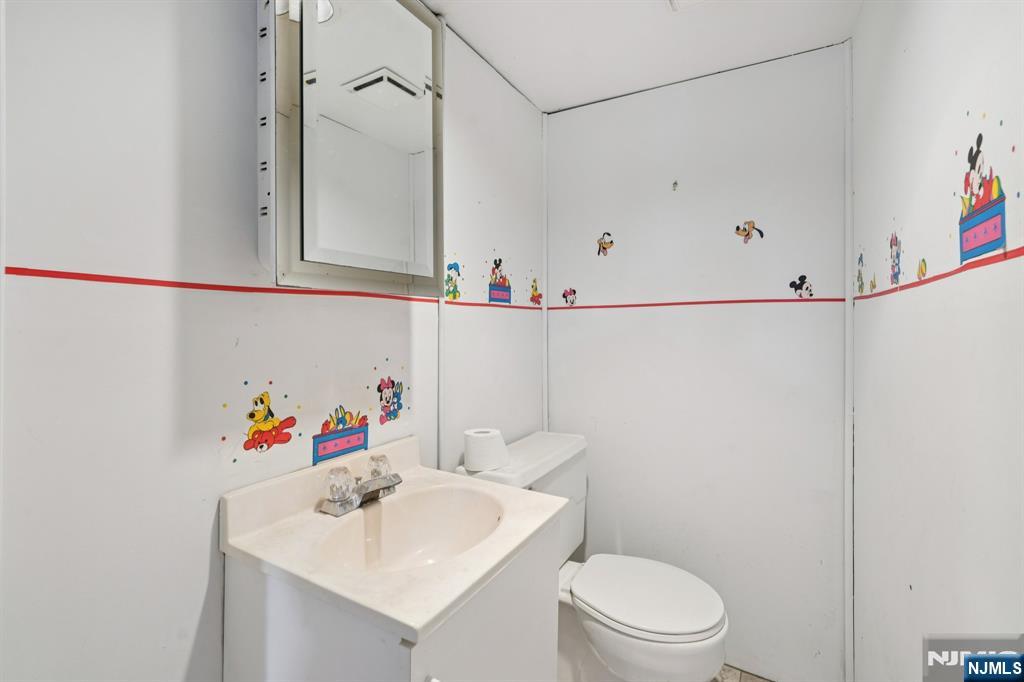 471 Harding Avenue Lyndhurst, NJ 07071 - Photo 46 of 50 a bathroom with a sink vanity mirror and toilet