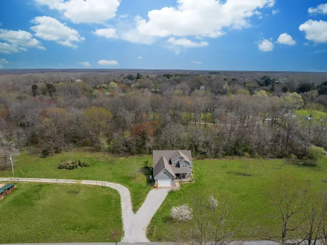 an aerial view of a golf course with chairs