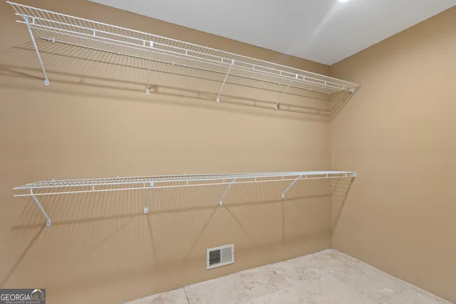 a view of empty room with wooden floor and fireplace