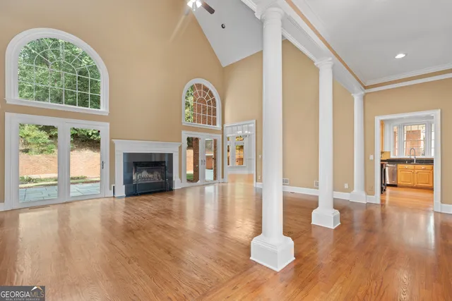 a view of empty room with wooden floor