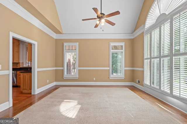 a kitchen with stainless steel appliances granite countertop a refrigerator a oven a stove and a sink with wooden floor