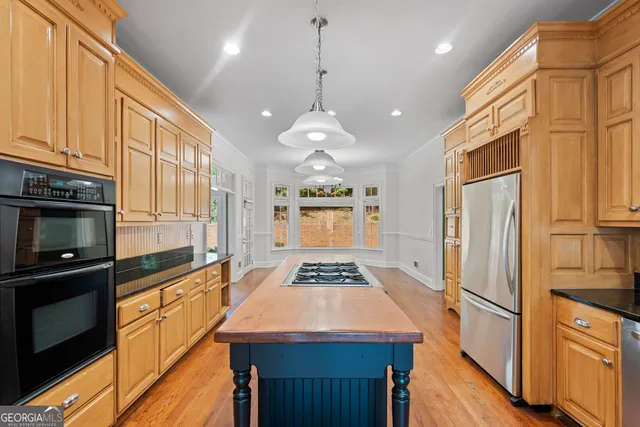 a kitchen with a stove and a wooden floor