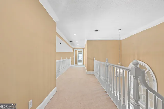 en empty room with windows and chandelier fan