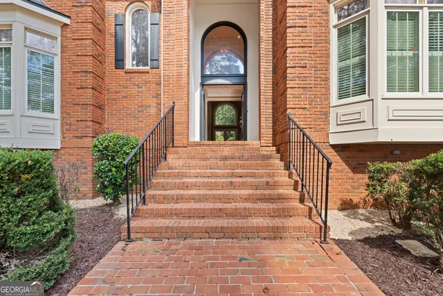 a front view of a house with a garden
