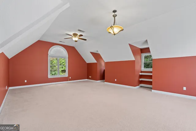 a view of a big room with closet and ceiling fan