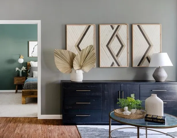 a living room with furniture and a potted plant