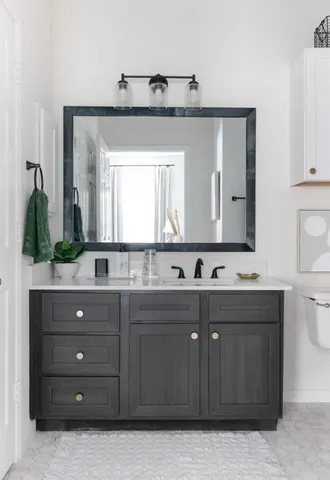 a bathroom with a sink vanity and mirror